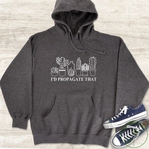 May include: A dark grey hooded sweatshirt with a white graphic of a row of potted cacti and the text "I'd propagate that".
