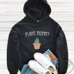 May include: Black hooded sweatshirt with the text "PLANT MOMMY" in white lettering and a small illustration of a potted plant.