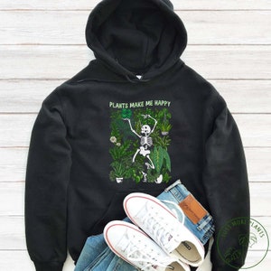 May include: Black hoodie featuring a skeleton surrounded by plants with the text "Plants Make Me Happy".