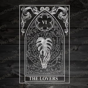 May include: A black and white tarot card with a silver design. The card is titled "THE LOVERS" and features a skeletal hand holding a monstera leaf. The card number "VI" is in the top center of the card.