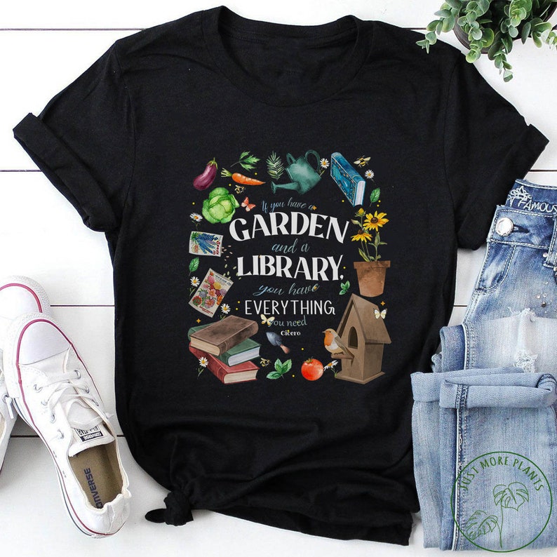 May include: Black t-shirt with a white graphic design featuring a garden and library with the text "If you have a garden and a library, you have everything you need - Cicero".