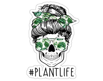May include: Black and white skull with green floral print bandana and sunglasses. The text #PLANTLIFE is below the skull.