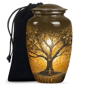 May include: A brown metal urn with a gold and black tree design. The tree has a full canopy with a moon and butterflies. A figure is sitting at the base of the tree. The urn comes with a black velvet bag.