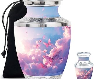 May include: A silver cremation urn with a pink butterfly design on a blue and pink cloudy sky background. The urn comes with a black velvet bag.