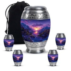 May include: Set of six silver metal cremation urns with a purple and blue mountain sunset scene. The urns come in two sizes, with a larger urn and five smaller urns. The urns are packaged with a black velvet drawstring bag.