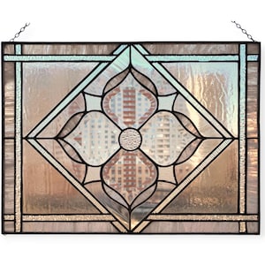 May include: A stained glass window panel with a geometric design featuring a four-leaf clover motif in a diamond shape. The glass is clear with a subtle iridescent sheen.
