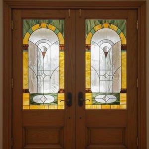 May include: A pair of wooden doors with stained glass panels. The glass features an arched design with yellow, green, and clear glass. The wooden doors have a natural finish and dark hardware.