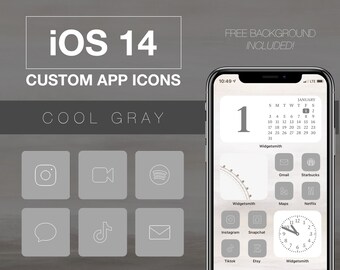 Pode incluir: Uma maquete de tela de iPhone mostrando um design de ícone de aplicativo personalizado para iOS 14. Os ícones estão em um esquema de cores cinza frio e incluem aplicativos populares como Instagram, TikTok e Spotify. A tela do telefone também mostra um widget de calendário com a data 1 de janeiro.