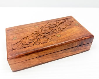 Carved wooden box with red fabric lining