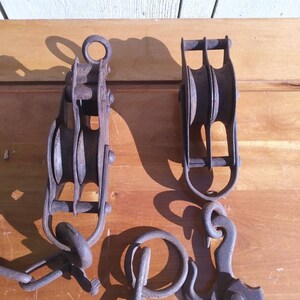 Two Vintage Pulleys with Attached Chain