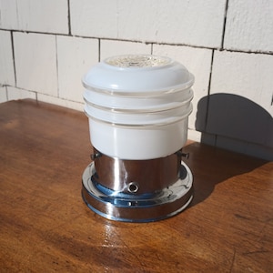 May include: A vintage chrome and white glass ceiling light fixture with a layered glass shade.