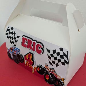 Dimensions: 16 cm long and 9 cm wide. ​3D Elements: The name, age, and monster trucks on the front are layered for a "pop-out" 3D effect.