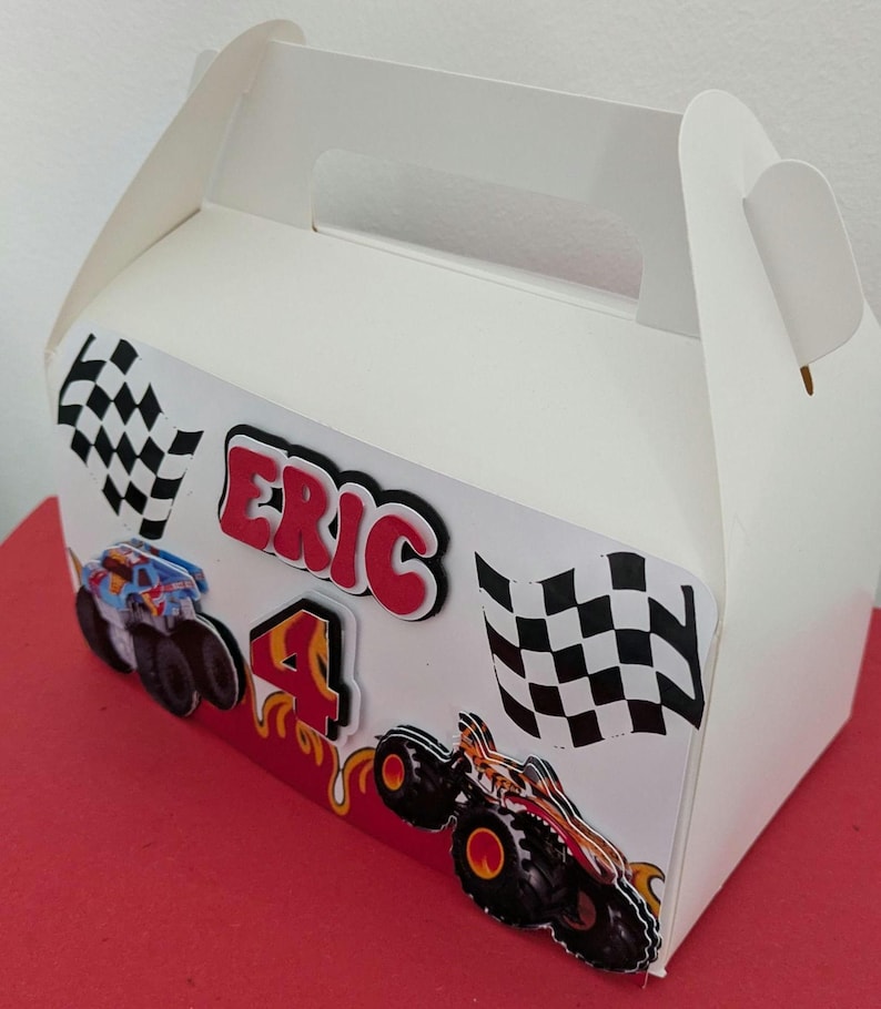 Dimensions: 16 cm long and 9 cm wide. ​3D Elements: The name, age, and monster trucks on the front are layered for a "pop-out" 3D effect.