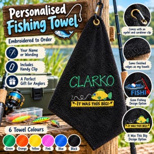 May include: A black embroidered fishing towel featuring the name Clarko in green thread above a yellow fish graphic and the text It was this big. The towel includes a gold-toned metal eyelet and a silver carabiner clip for attachment.