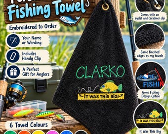 May include: A black embroidered fishing towel featuring the name Clarko in green thread above a yellow fish graphic and the text It was this big. The towel includes a gold-toned metal eyelet and a silver carabiner clip for attachment.