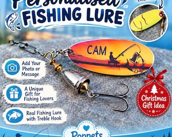 May include: A metal fishing lure featuring an oval blade with a sunset graphic, the name CAM, and a silhouette of a person fishing. The lure includes a silver and gold-toned weight, a treble hook, and a swivel connector. Text includes Personalised Fishing Lure, Add Your Photo or Message, A Unique Gift for Fishing Lovers, Real Fishing Lure with Treble Hook, Christmas Gift Idea, and Poppets Handmade Shop.