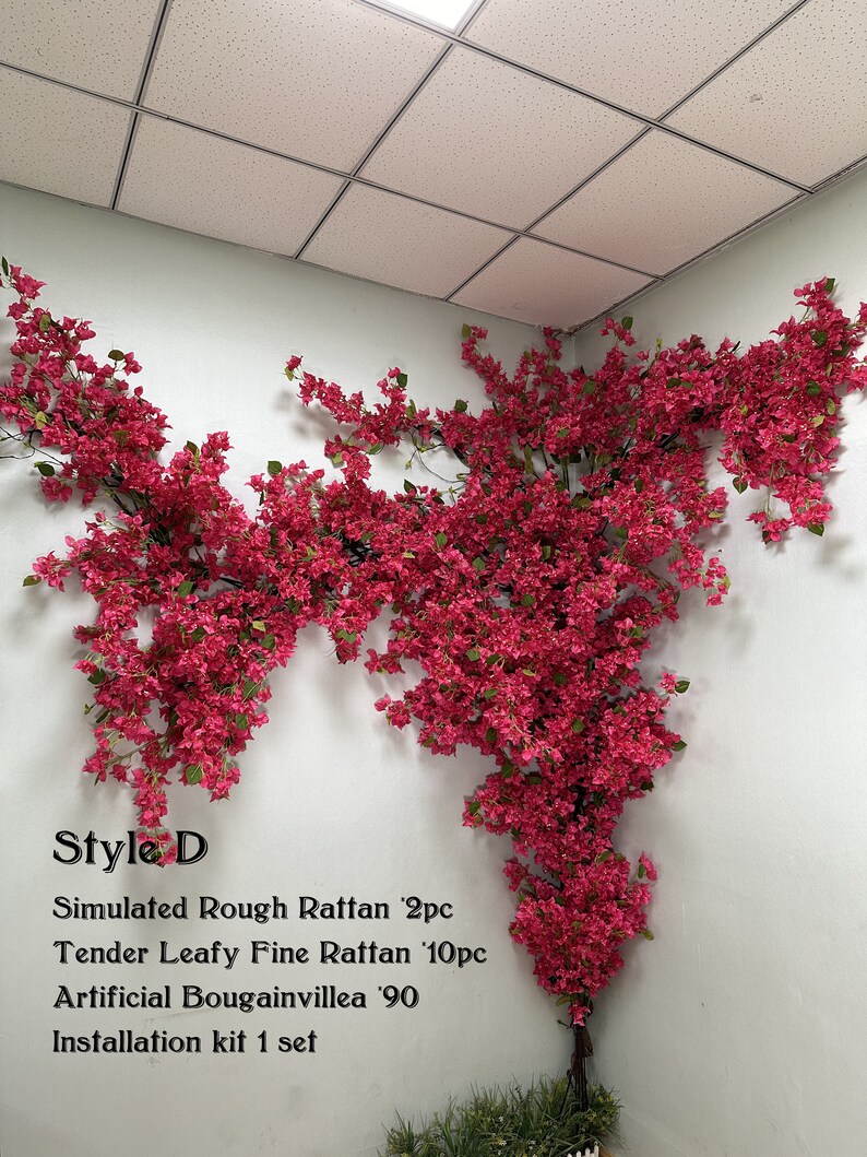 May include: Artificial bougainvillea plant with pink flowers, displayed against a white wall. The plant is part of a decorative set that includes simulated rough rattan and fine rattan.