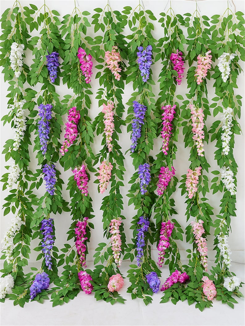 May include: Artificial wisteria vines with green leaves and cascading flower clusters in shades of white, purple, pink, and peach. These decorative vines are ideal for adding a touch of nature to any space.