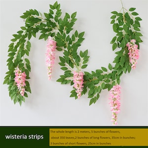 May include: Artificial wisteria strips with green leaves and pink flower clusters. The whole length is 2 meters, with 5 bunches of flowers, about 350 leaves, 2 bunches of long flowers (35cm in bunches), and 3 bunches of short flowers (25cm in bunches).