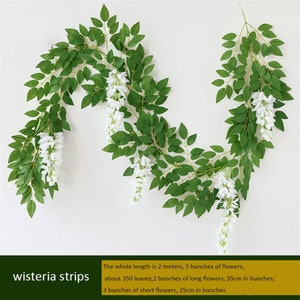 May include: Artificial wisteria strips with green leaves and white flowers. The whole length is 2 meters, with 5 bunches of flowers, about 350 leaves, 2 bunches of long flowers (35cm in bunches), and 3 bunches of short flowers (25cm in bunches).
