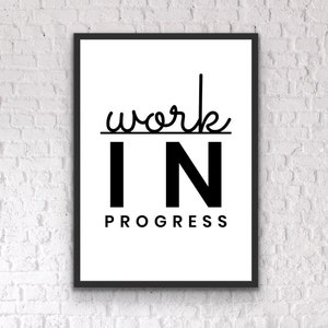 May include: Black and white framed print with the text "work in progress" in a modern font.