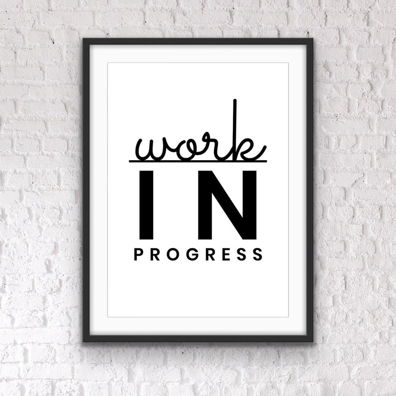 May include: Black and white framed print with the text "work in progress" in a modern font.