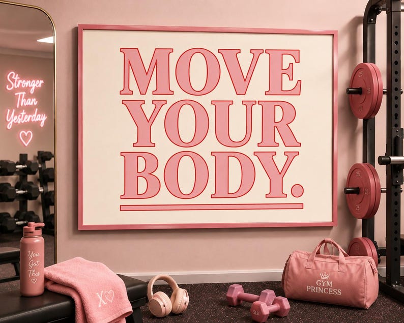 May include: Pink framed wall art with the words "MOVE YOUR BODY" in a bold font. A pink water bottle, towel, headphones, dumbbells, and a gym bag are in the foreground. A mirror and weight rack are in the background.