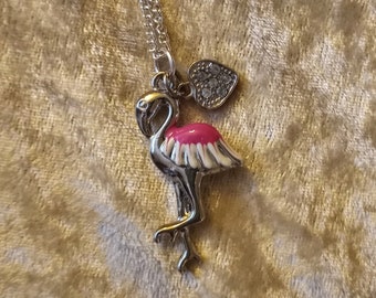 Partly enameled silver flamingo pendant on a silver chain with small crystal heart