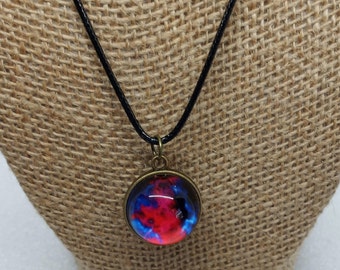Glow in the dark double sided planetary glass pendant on black leather cord
