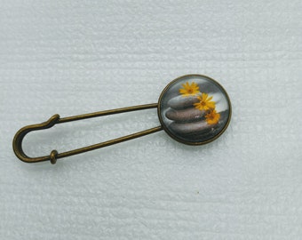 Glass cabochon Zen setting of stacked rocks and daisies shawl pin set in antique gold