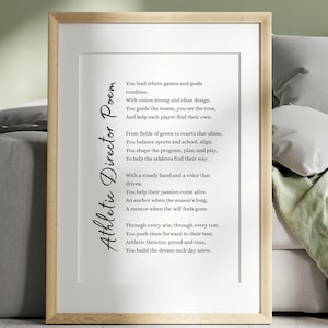 Op de afbeelding: Een ingelijste print met het gedicht "Athletic Director Poem" in zwart script. Het gedicht staat op een witte achtergrond, in een licht houten frame. De print wordt weergegeven op een neutrale achtergrond.