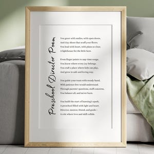 May include: A framed print with the poem "Preschool Director Poem" displayed in black text on a white background. The frame is light wood. The poem celebrates the role of a preschool director.