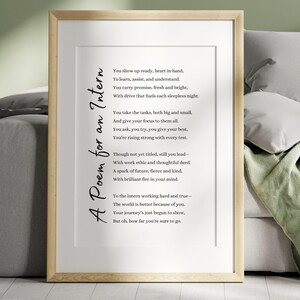 May include: A framed print with a light wood frame. The print features a poem titled "A Poem for an Intern" in black script. The poem is centered on a white background.