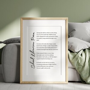 May include: A framed print featuring a poem titled "School Librarian Poem." The text is in black against a white background, with a wooden frame. The poem is dedicated to school librarians.