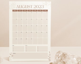 May include: A printable August 2023 calendar with a to-do list and notes section. The calendar has a minimalist design with brown text and floral accents.