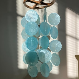 Turquoise Capiz Shell Wind Chime | Capiz shell chime, Capiz shell mobile, shell mobile, home decor, capiz shell, wind chimes, nursery mobile