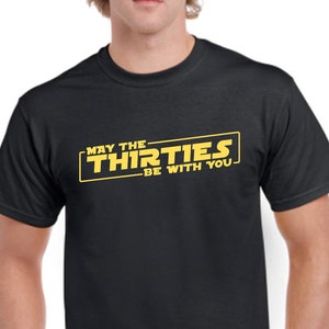 May include: Black t-shirt with a yellow graphic that says "May the Thirties Be With You" in a Star Wars-inspired font.