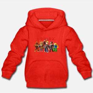 May include: Red hooded sweatshirt with a white drawstring and the word "ROBLOX" printed in white on the front. The graphic features a group of cartoon characters from the popular online game.