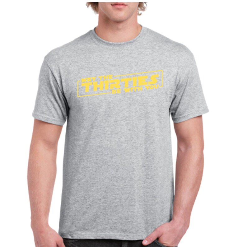 May include: Gray t-shirt with a yellow graphic that says "May the Thirties Be With You".