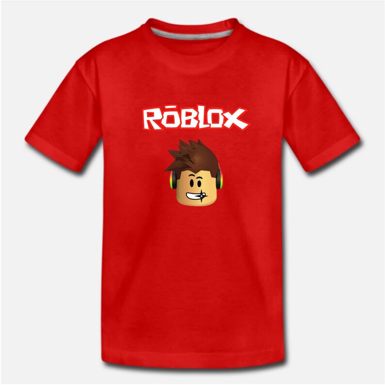 Puede incluir: Camiseta roja con un logotipo "ROBLOX" blanco y un personaje de dibujos animados con auriculares.