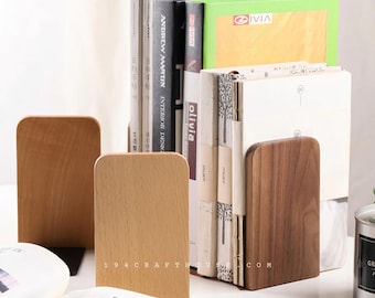 May include: Two sets of wooden bookends, one set is light brown and the other is dark brown. The bookends are holding up a stack of books with various titles.