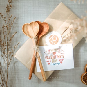 Handmade wooden heart spoon with custom text for anniversary celebrations.