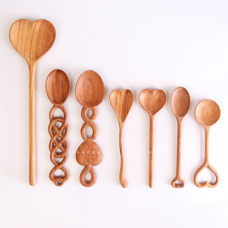 Heart-shaped spoon made from wood with custom names for wedding gifts.