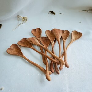 Set of personalized wooden heart spoons for bridal shower favor bags.