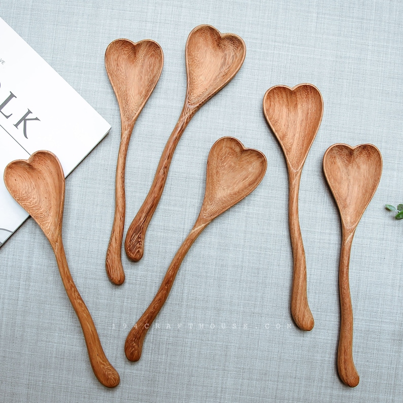 Engraved heart-shaped wooden spoon as a personalized wedding keepsake.