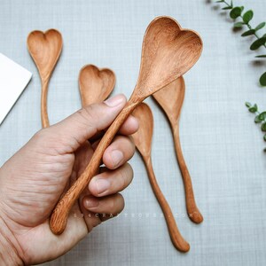 Wooden spoon with heart-shaped head, engraved for bridal shower favors.