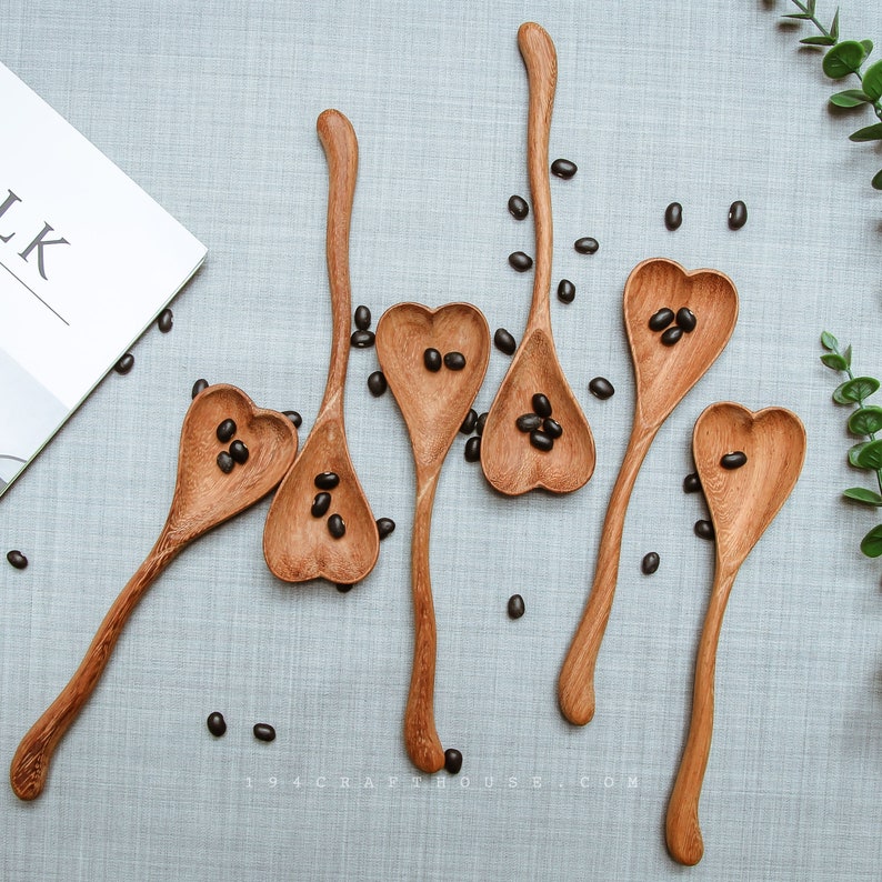 Elegant wooden heart spoon engraved with initials for wedding celebrations.