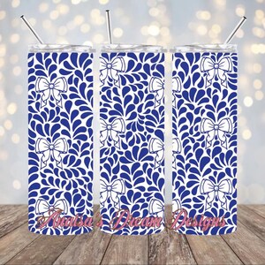 May include: Three stainless steel tumblers with a white background and a blue and white pattern of stylized leaves and bows.