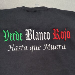 May include: Black t-shirt with green, white, and red embroidered text that reads "Verde Blanco Rojo Hasta que Muera".
