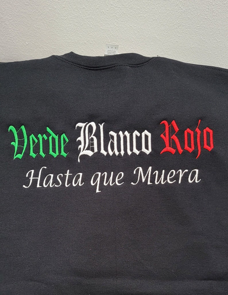 May include: Black t-shirt with green, white, and red embroidered text that reads "Verde Blanco Rojo Hasta que Muera".